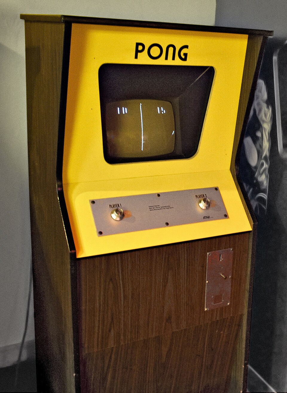 Sarı Atari Pong salon kabini; ekranda iki çubuk ve bir top