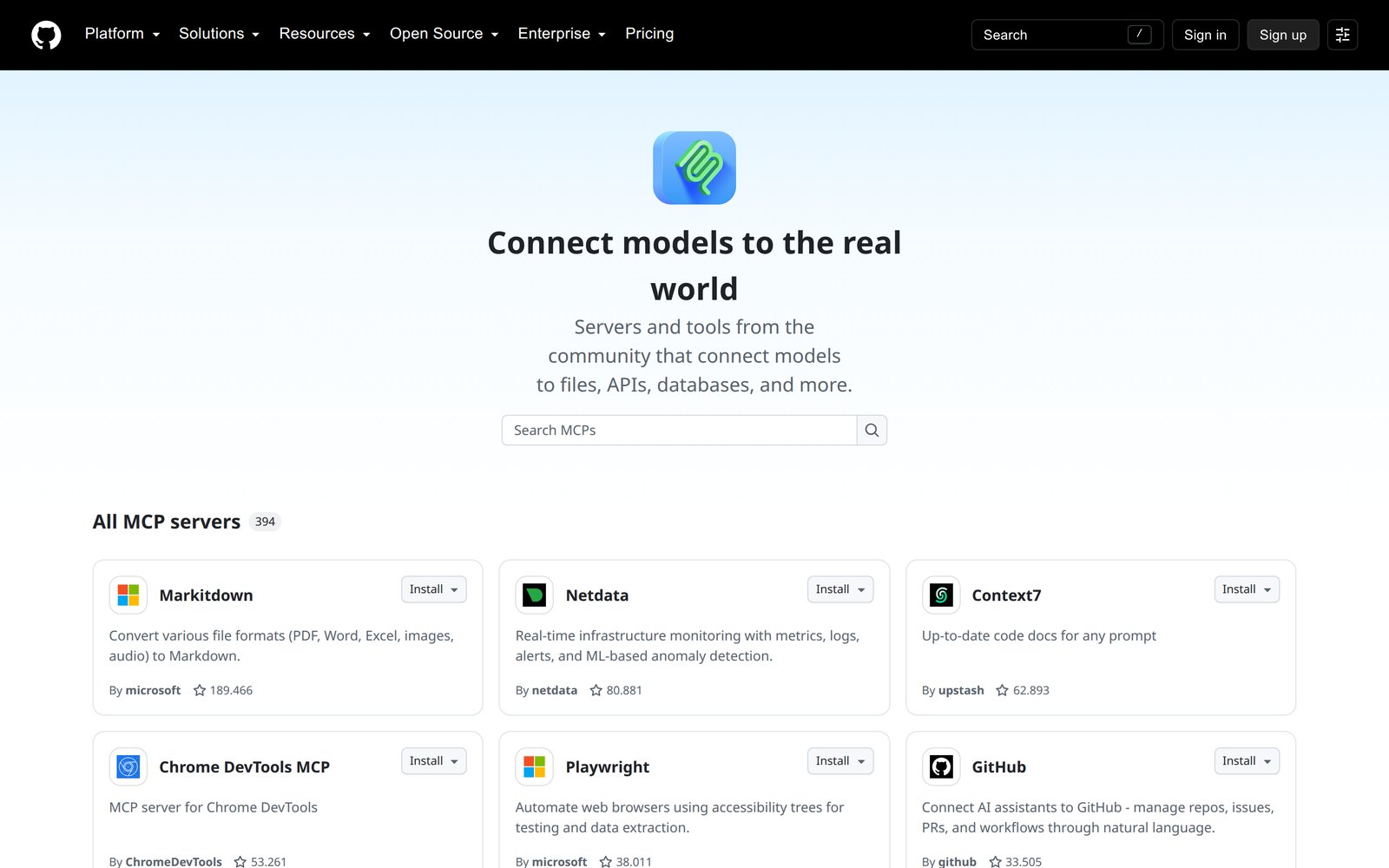 GitHub'ın MCP dizini: 'Connect models to the real world' başlığı, bir arama kutusu ve 'All MCP servers 394' listesi. Kartlarda sunucu adı, kısa açıklama, yayımcı ve yıldız sayısı: Markitdown (Microsoft), Netdata, Context7 (Upstash), Chrome DevTools MCP, Playwright (Microsoft), GitHub; her kartta Install düğmesi.