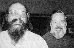 Siyah beyaz fotoğraf: sakallı, gözlüklü Ken Thompson ve yanında gülümseyen Dennis Ritchie